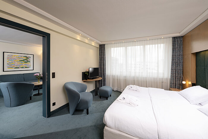 ProArte Suite Suite bedroom with double bed and view into the living room at Maritim proArte Hotel Berlin