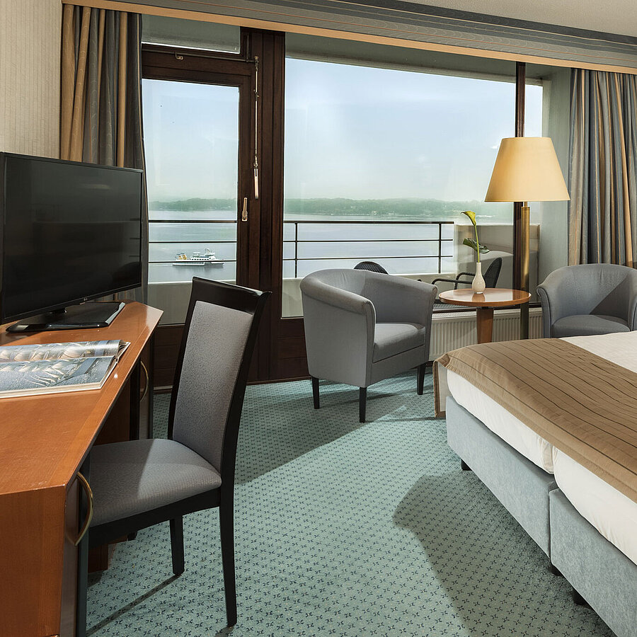 Superior room Superior room at the Maritim Hotel Kiel with desk, seating area, large double bed and balcony overlooking the fjord.