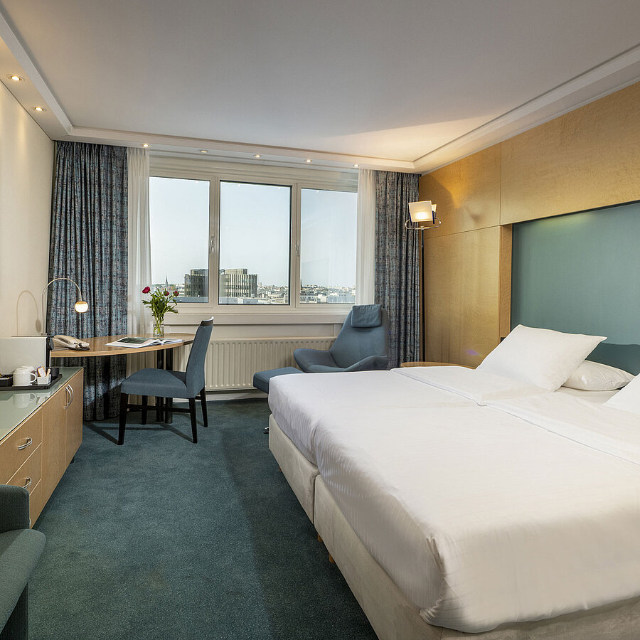 Superior room Modernly furnished Superior room at Maritim proArte Hotel Berlin with large bed, desk, artwork, and city view from the window
