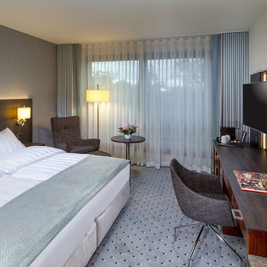 Superior Double room Modern Superior double room at Maritim Hotel Bremen with seating area, desk, and large window for natural light.